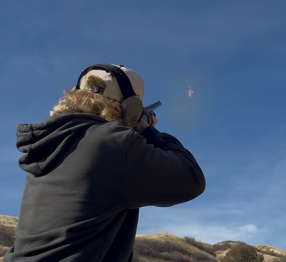 Clay shooting experience - shooter aiming at clay targets